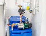 Impianto idraulico con serbatoio blu, pompa e vaso di espansione. Un autoclave per aumentare pressione acqua, pronto all'uso.
