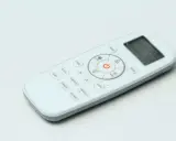 Telecomando bianco con vari simboli condizionatore: ON/OFF, temperatura, modalità, timer, sleep, smart, quiet, dimmer, economy.