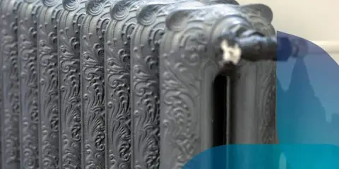 Dettaglio di eleganti termosifoni in ghisa con decorazioni floreali, un classico intramontabile per un riscaldamento di stile.